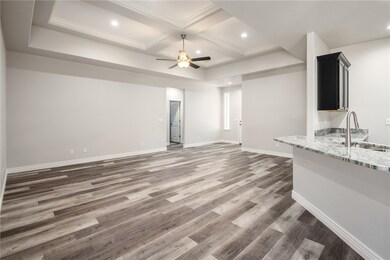 Unfurnished living room featuring a sink, ceiling