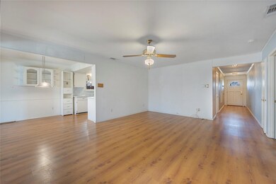 Unfurnished living room featuring ceiling fan and 