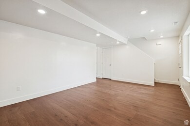 Basement with wood finished floors and recessed lighting