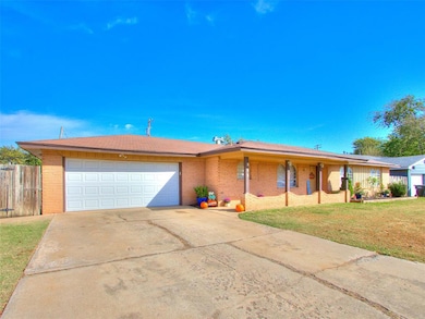 Single story home with brick siding, driveway, an attached garage, and covered porch