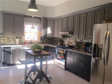 Beautifully updated kitchen with glass tile backsp