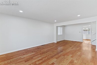 Living room with light hardwood / wood-style floor
