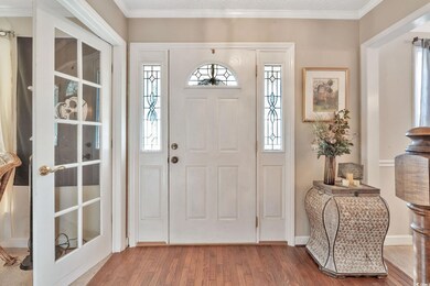 Foyer entrance with hardwood / wood-style flooring