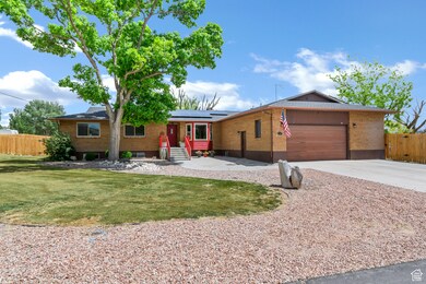 Ranch-style home featuring roof mounted solar panels, a garage, brick siding, concrete driveway, and entry steps