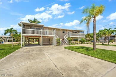 View of front of property with a carport, covered