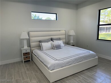 Bedroom with wood finish floors and baseboards