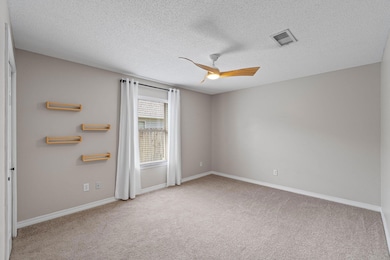 Bedroom 2 looks out over the side yard. This is the only bedroom with carpet.