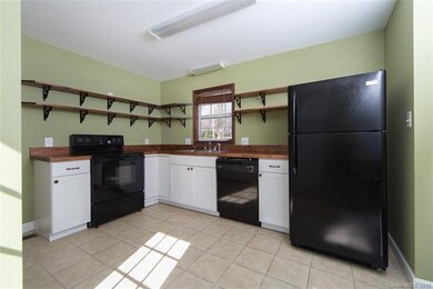 Brand new kitchen with tile floor, custom stained butcher block counters, new cabinets and appliances