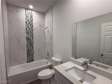 Bathroom featuring  shower combination and vanity