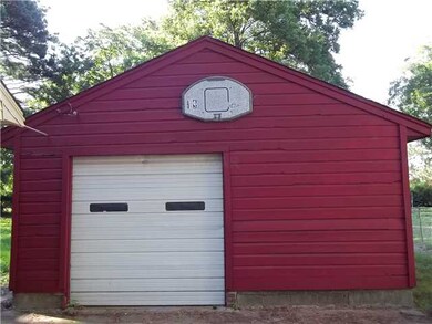 One car detached garage with a storage area behind