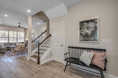 Stairway featuring recessed lighting, visible vents, ceiling fan, wood finished floors, and baseboards