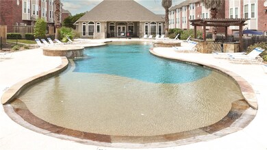 View of pool with a pergola and a patio