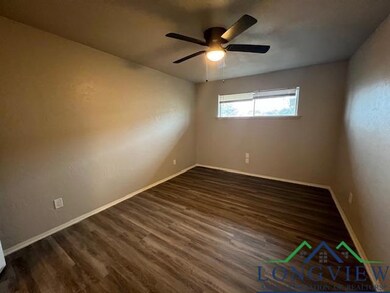 Unfurnished room featuring dark wood-style floors,