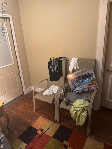 Dining space featuring dark wood-style floors and baseboards