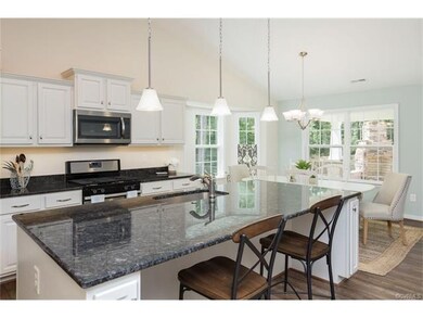 Photo shows model home kitchen/dining - Powell flo