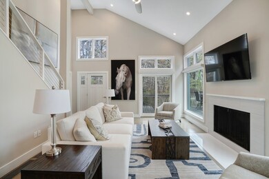 Light-filled living area with wood fireplace.