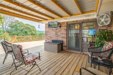 Spacious covered deck with mounted TV