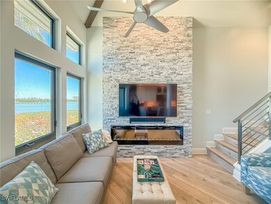 Living area with ceiling fan, beamed ceiling, stai
