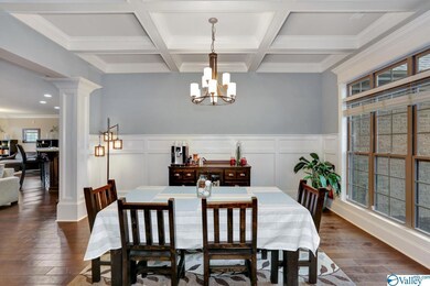 Formal Dining Room with wainscoting and coffered ceilings.