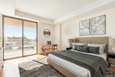 Bedroom featuring wood finished floors, a desk, access to exterior, a view of city, and a tray ceiling