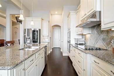 Kitchen featuring tasteful backsplash, dark hardwo