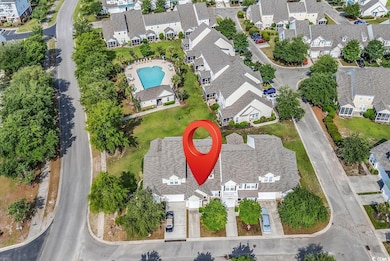 Aerial view of property's location featuring a pool and nearby suburban area