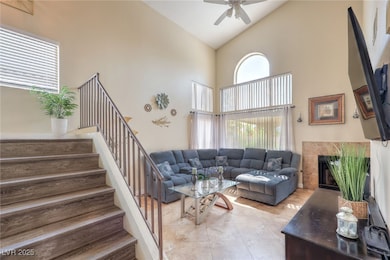 Living room featuring high vaulted ceiling, a ceil