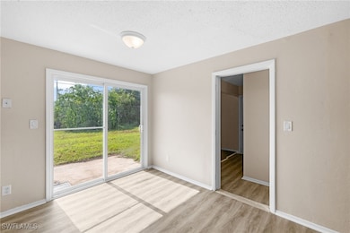 dining area with light wood-style flooring and a t