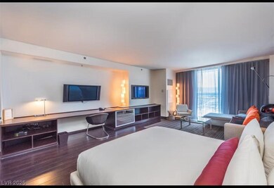 Bedroom featuring a wall of windows and wood finis