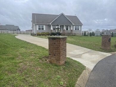The brick entry columns and concrete driveway create a welcoming impression for guests and family.                                                                                       Located on one acre in a quiet cul de sac.