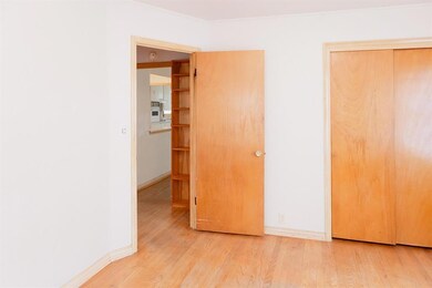 Unfurnished bedroom featuring crown molding, a clo