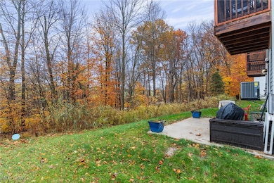 View of grassy yard featuring a patio area