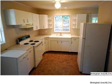 White kitchen with views to side yard and privacy 