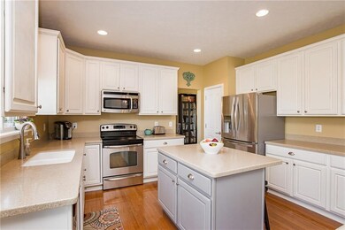 Kitchen with stainless steel applicances, lightly distressed cabinets.