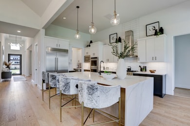 Kitchen showcasing tons of upgrades and the luxuri