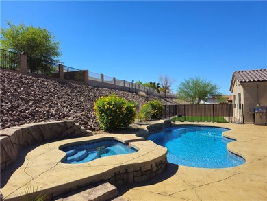 View of pool featuring grilling area, a fenced bac