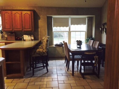 Breakfast counter and informal dining area with ba