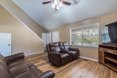Living room with wood finished floors, baseboards