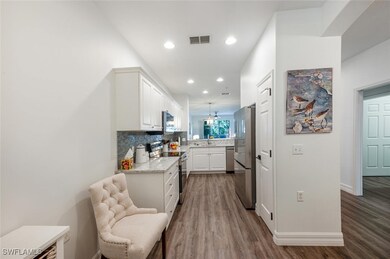 Kitchen with visible vents, a sink, stainless stee