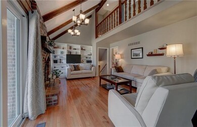 Loft overlooks Family Room Fireplace and Wood Beam