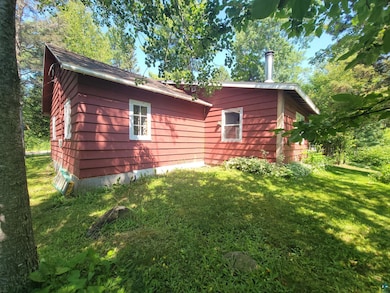 View of side of home with a lawn