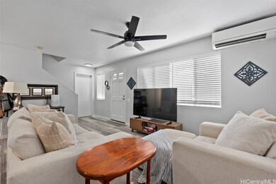 Front door and garage door visible. Living room ca