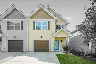 View of front of house with concrete driveway and an attached garage