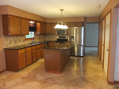 Fully applianced kitchen with granite countertops.