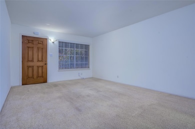 Unfurnished room with carpet and baseboards