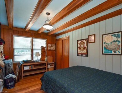 Office/flex space currently being used as a bedroom. With gorgeous hardwoods, wood beams, built-in desk and closet.