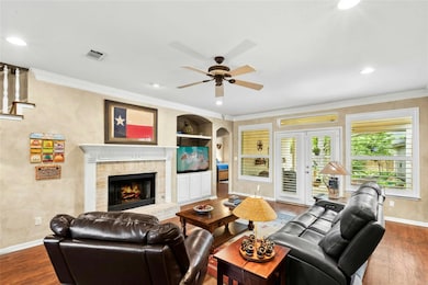 Living room featuring ceiling fan, dark wood fini