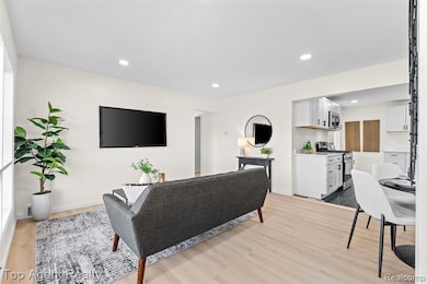 Living area featuring recessed lighting and light wood-style flooring