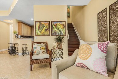 Living area with stairway, baseboards, light tile 