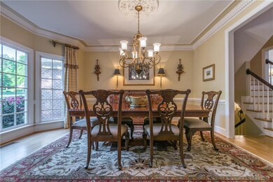 The expansive dining room is conveniently located next to the kitchen and can easily accommodate a long, rectangular table.  The convenient back staircase situated between the kitchen and dining room provides easy access to both the basement and second floor.